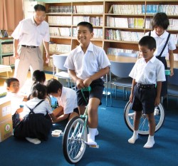 組み立てた新しい一輪車にまたがり、にっこり